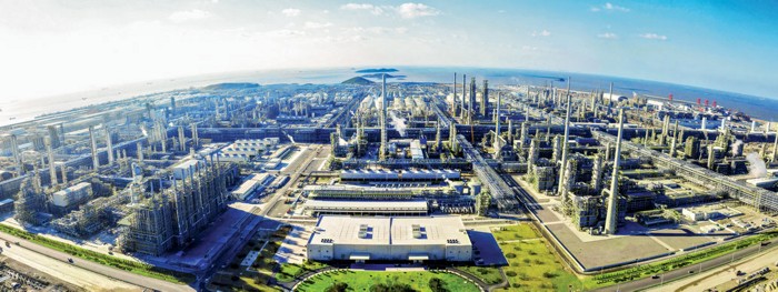 The massive Zhejiang Petroleum and Chemical complex in China. There is a large refining and petrochemical complex in the foreground and the ocean in the background.
