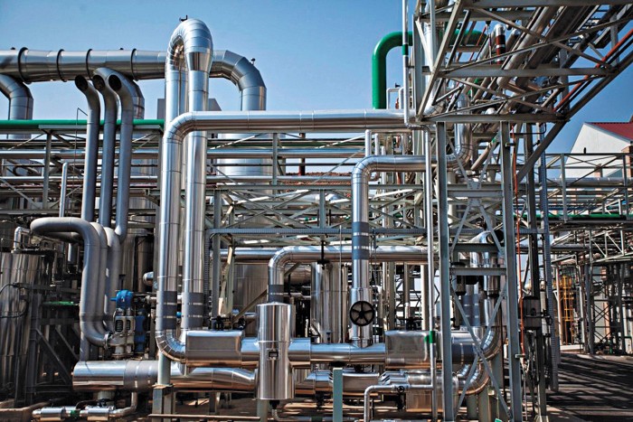 A chemical plant with a complex series of pipes snaking through it.