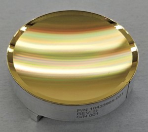 A concave golden plate appears streaked with color because of light bouncing off its surface.