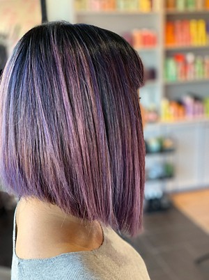 A person with a purple bob haircut.