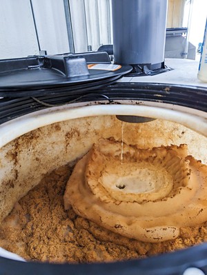 Thick foam rises to the surface inside a cylinder of a foam fractionation system.