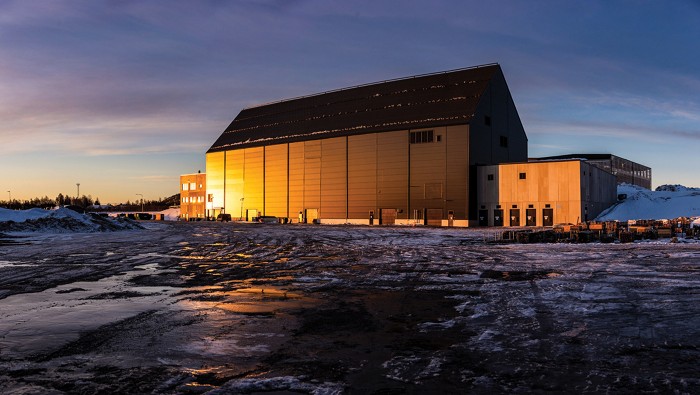 A gray building surrounded by ice.