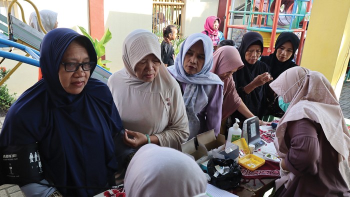 Women in line for a health screening in Indonesia