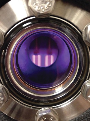 Image of a metal and glass chamber where scientists expose gases to plasma to learn more about exoplanet atmospheres.