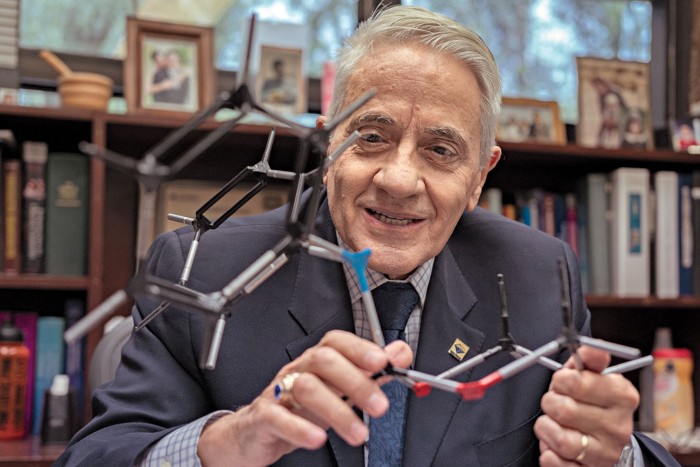 Eusebio Juaristi holds a molecule constructed from a ball-and-stick chemistry model.