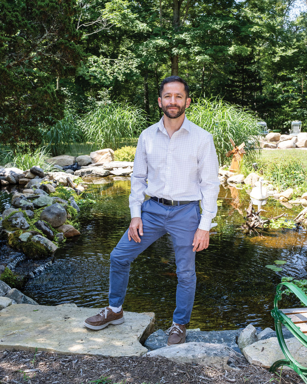 Carlos A. Martinez stands in front of a pond.