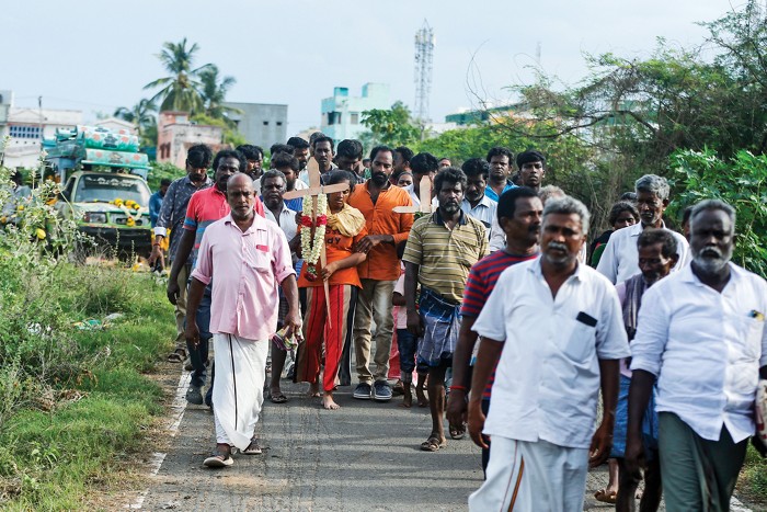 People walking in a funeral procession in India.