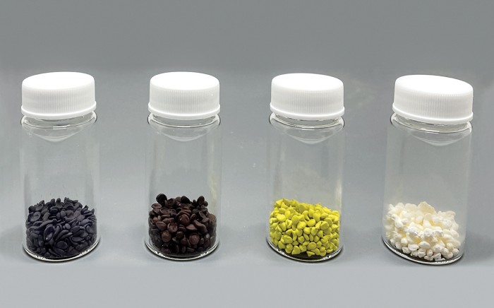 Three small jars with different colored beads inside.