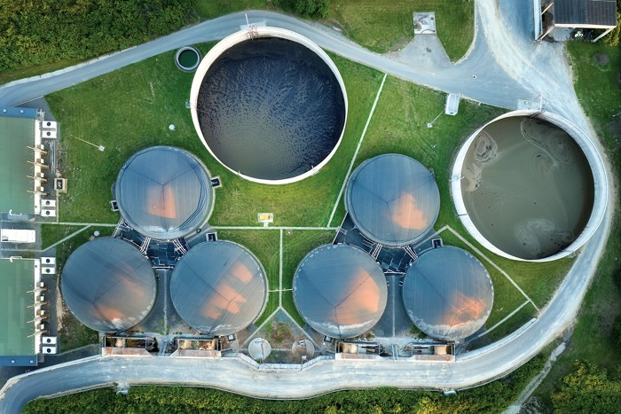 A shot of a water treatment installation from above shows vats of wastewater.
