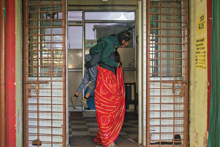 A woman carrying her child.
