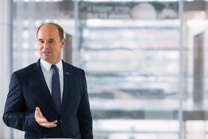 BASF chairman Martin Brudermüller in a modern space, bathed in natural light.