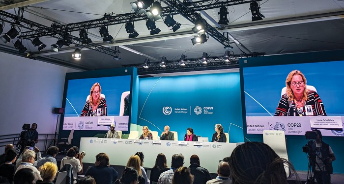 Image of Liane Schalatek, associate director of the Heinrich Böll Foundation, speaking at a press conference at COP29.