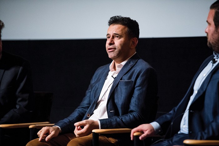 Marty Makary, seated and wearing a formal jacket, speaking on a panel onstage.