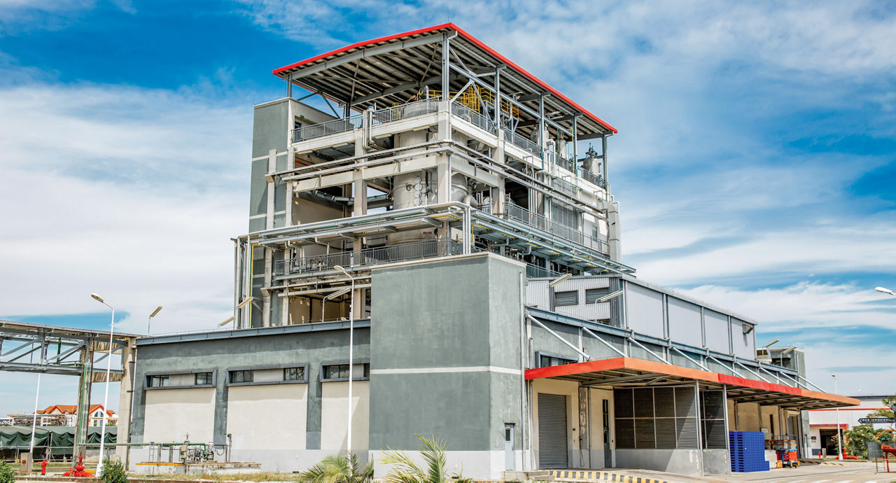 What appears to be a small chemical plant and a small lab-like complex in the foreground.
