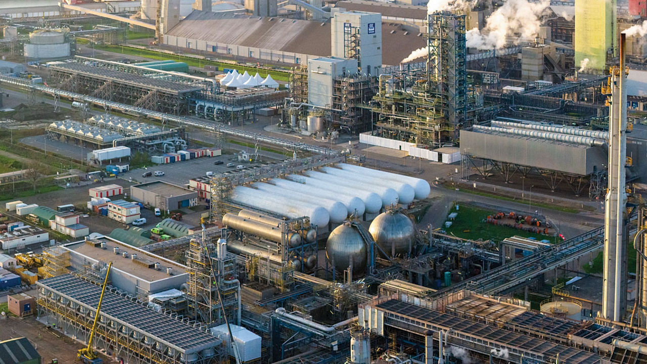 A large industrial facility with cylindrical and spherical storage tanks.