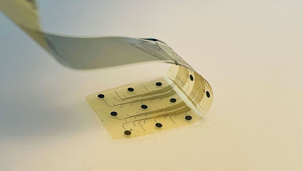 A thin, flexible electrode that looks like a piece of tape with black dots and lines on it.
