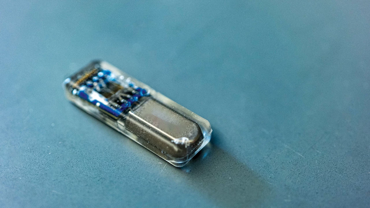 A shiny device in a transparent container.