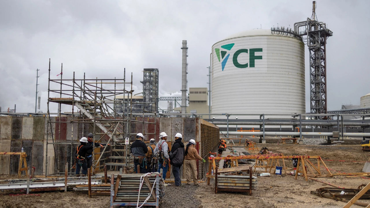 Workers wearing hard hats at an industrial construction site.