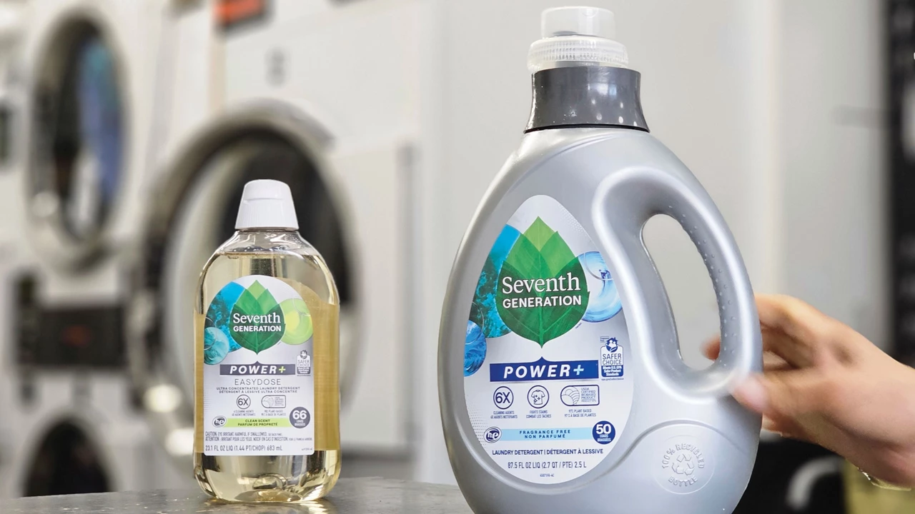Two bottles of Seventh Generation laundry detergent sit on a gray countertop. The one on the left is clear, and the other is gray.