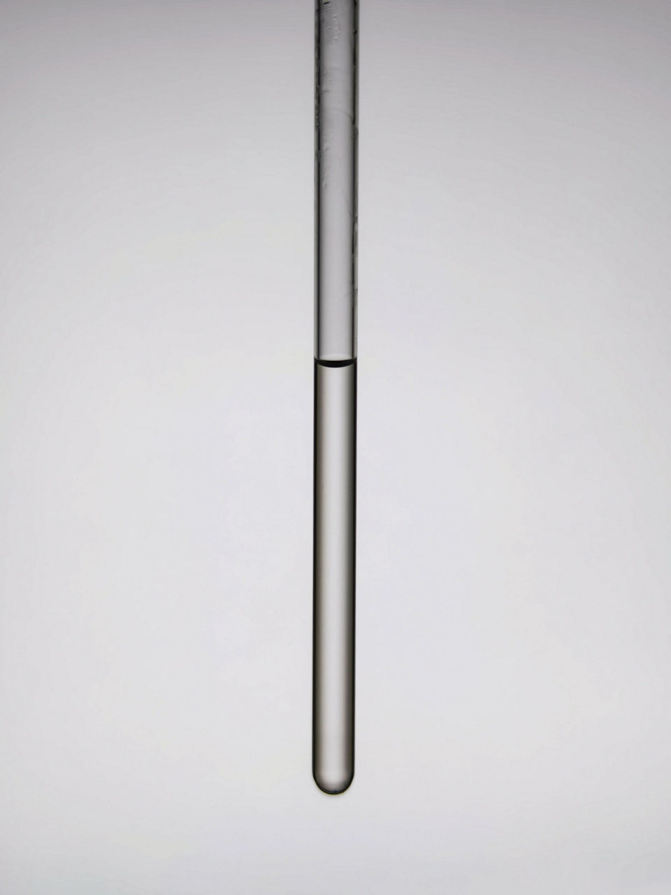 A sample of a liquid inside a small vial.