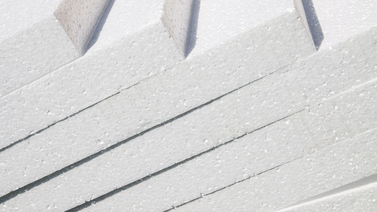 Rigid boards of white polystyrene lay diagonally on top of each other.
