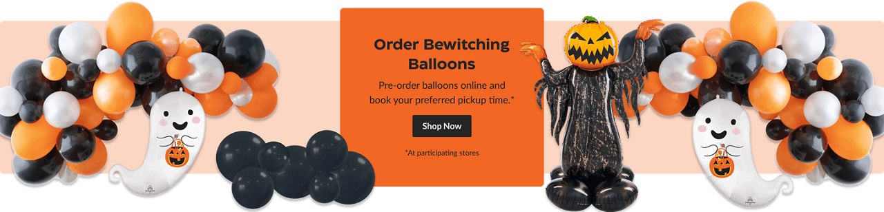 A pumpkin balloon and a shiny ghost balloon, surrounded by a garland of orange, black, and white balloons.