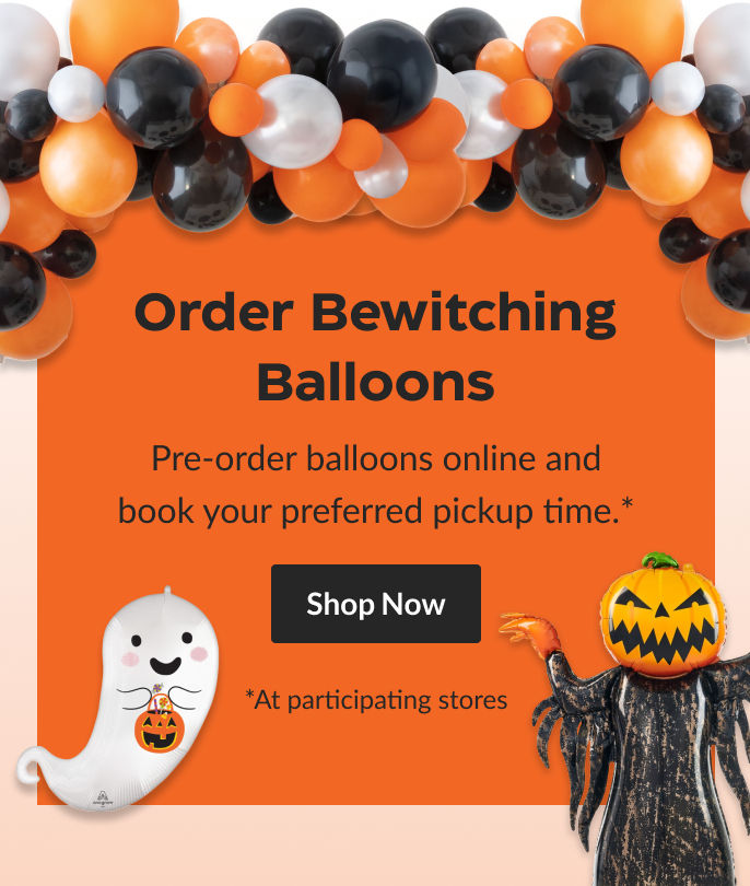 A pumpkin balloon and a shiny ghost balloon, surrounded by a garland of orange, black, and white balloons.