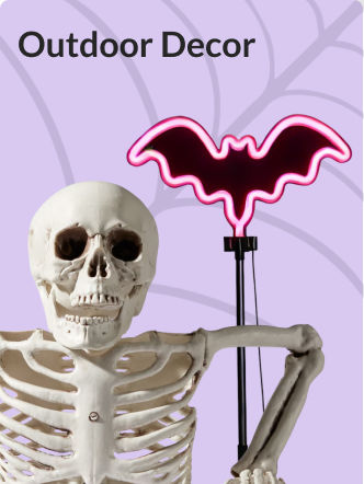 A bat decoration with a pink LED light on a stand set up next to a skeleton decoration.