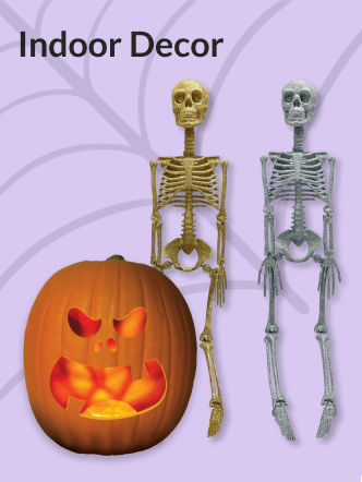 A glowing jack-o'-lantern next to a silver and gold skeleton.