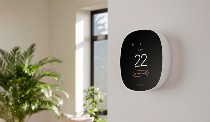 A smart home thermostat mounted on a wall.