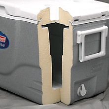 The corner of a Coleman Cooler with the sides cut away to display the insulation that runs from the bottom, up the sides and into the lid.