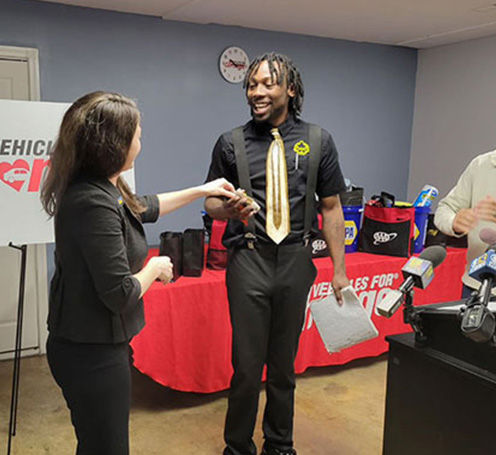 Vehicles for change program man getting keys