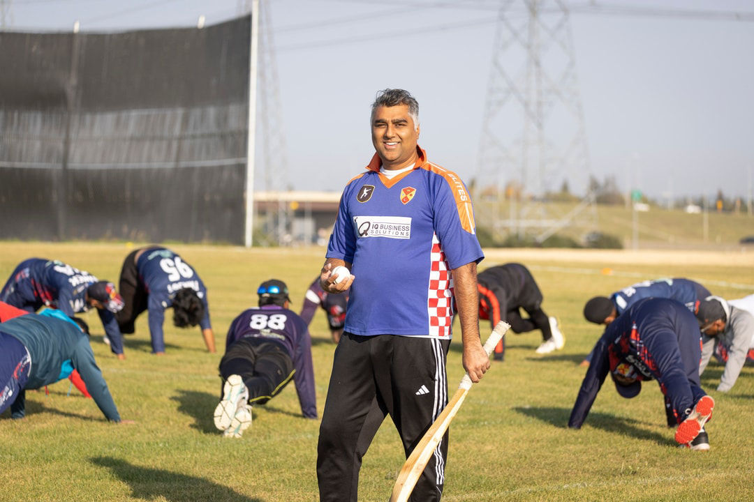 Anuj stands with his team as they warm up, guiding their growth on and off the pitch.