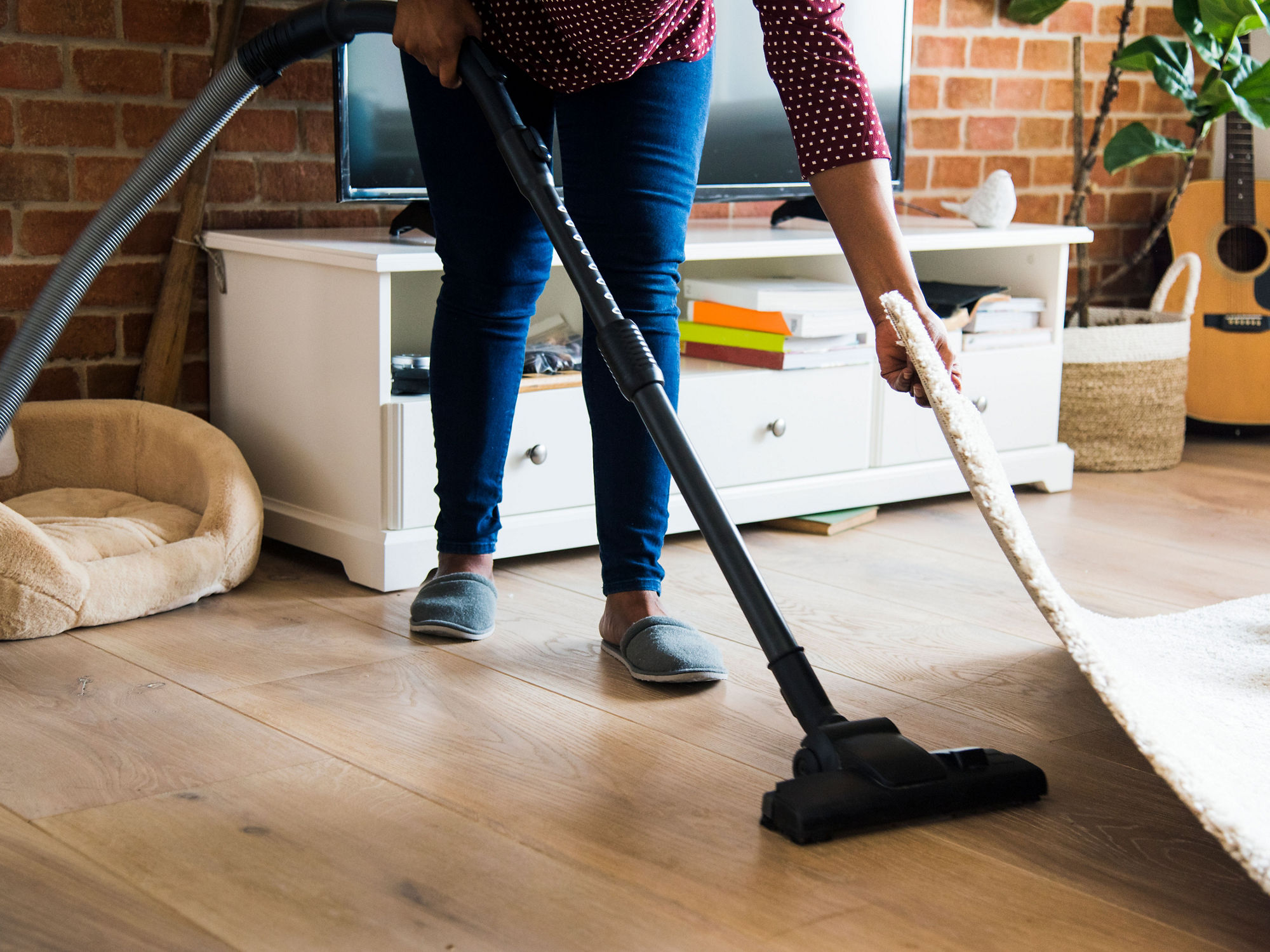 Cleaning the living room with vacuum