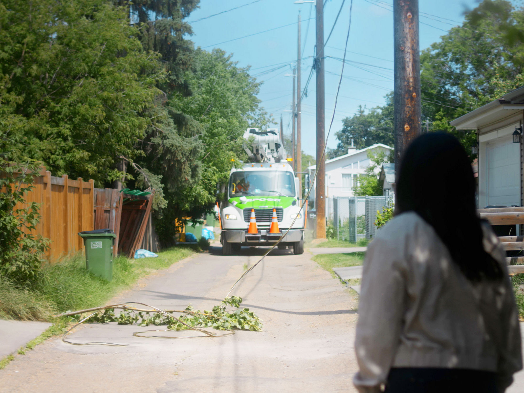 A person staying a safe distance from a downed power line