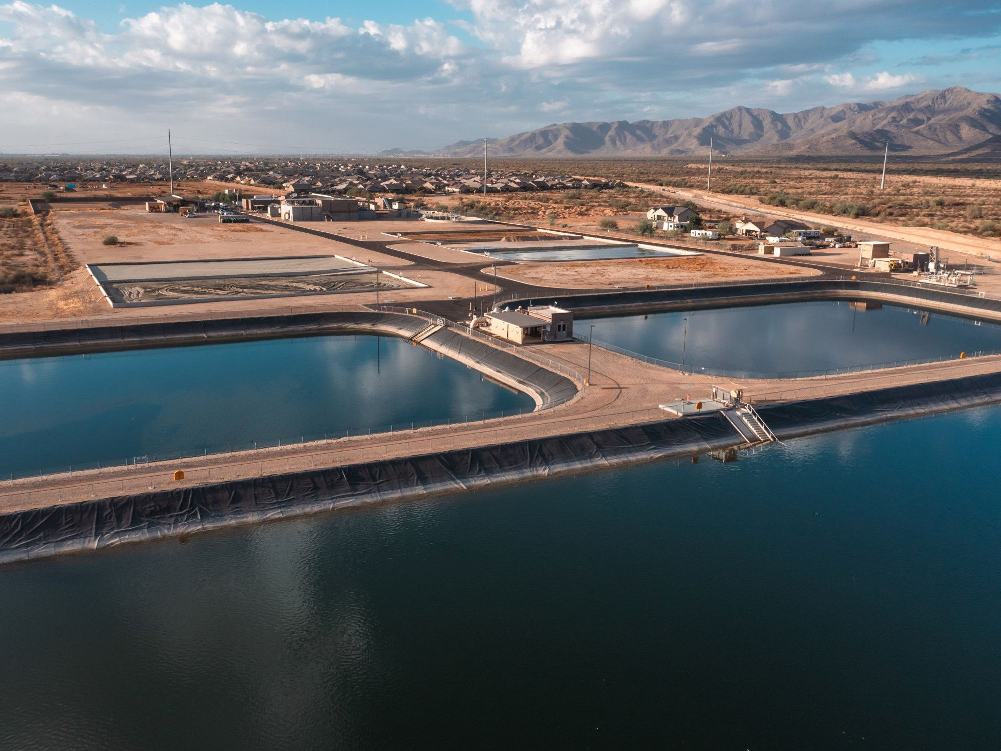 Aerial view of engineered water storage reservoirs and treatment basins supporting sustainable water management in an arid, fast‑growing community.