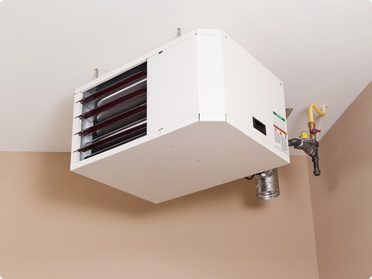 Woman sitting in front of a fan blowing air