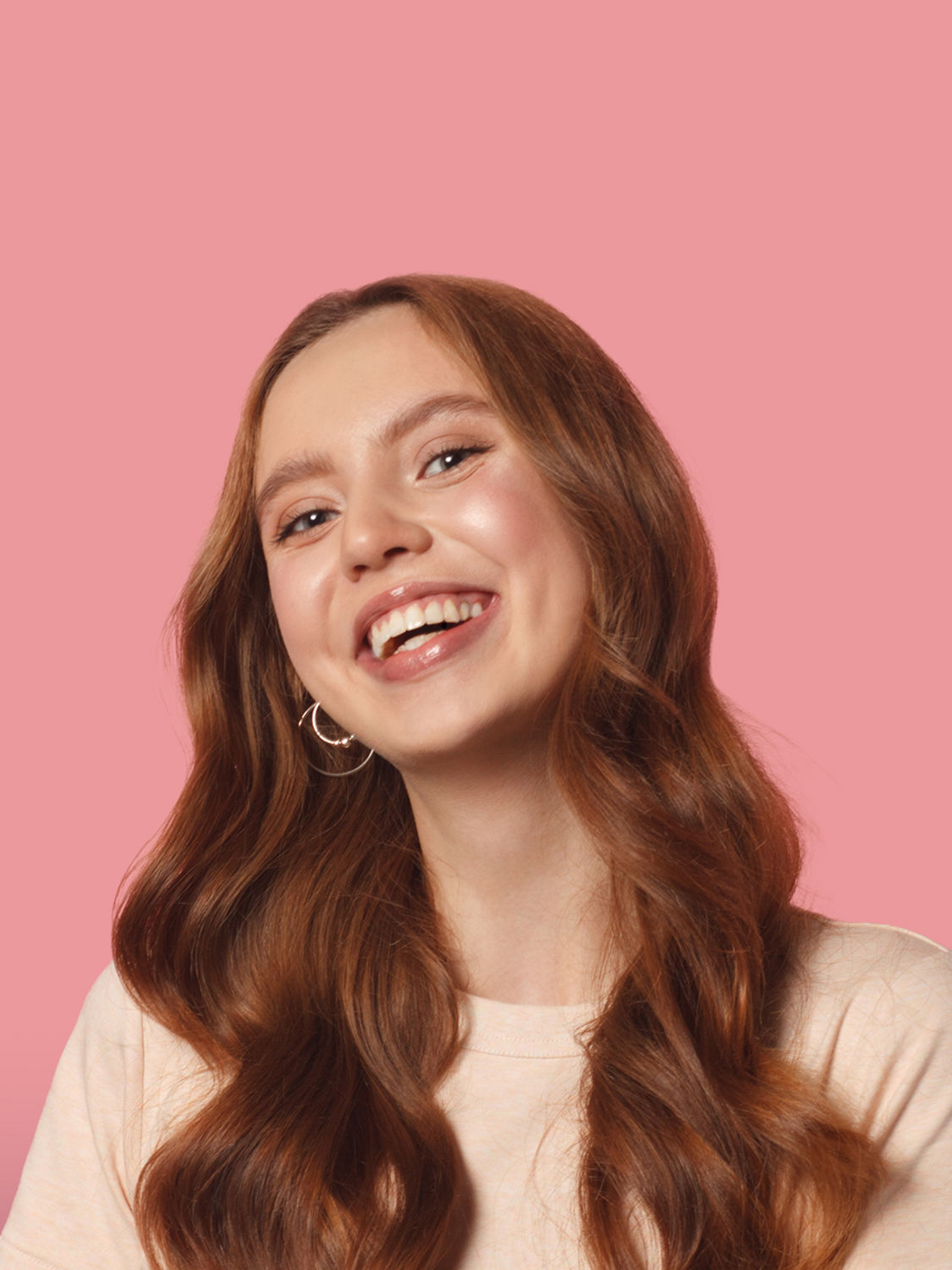 A close-up portrait on a soft pink background, highlighting a clean, approachable look that reflects simple and friendly energy plans from Encor by EPCOR.