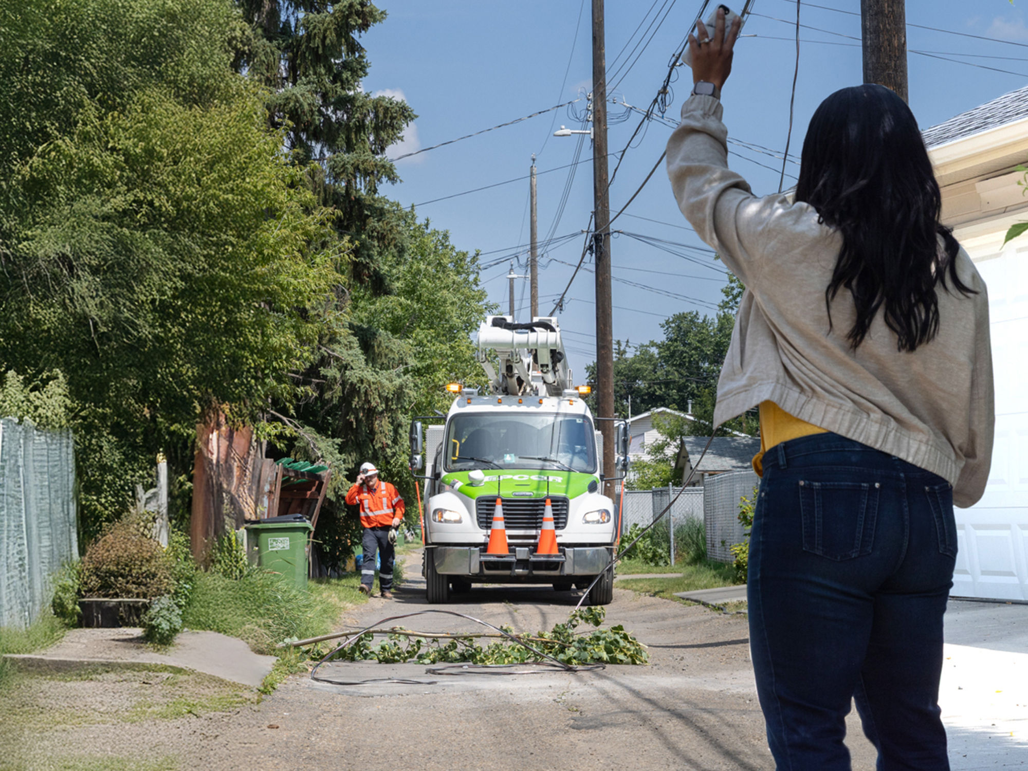 An EPCOR truck in an alley, coming to deal with a downed power line