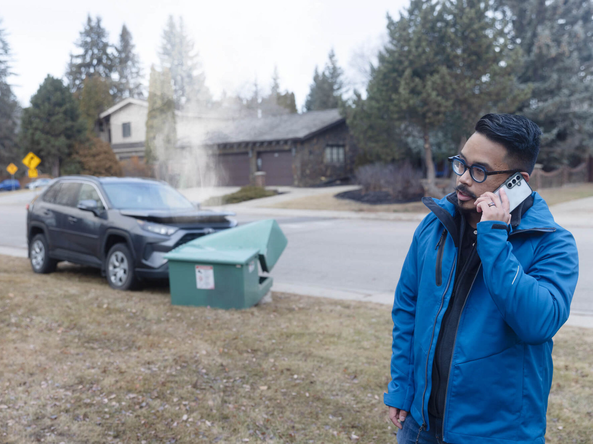 Someone calling to report a car has hit and damaged a green electrical box.