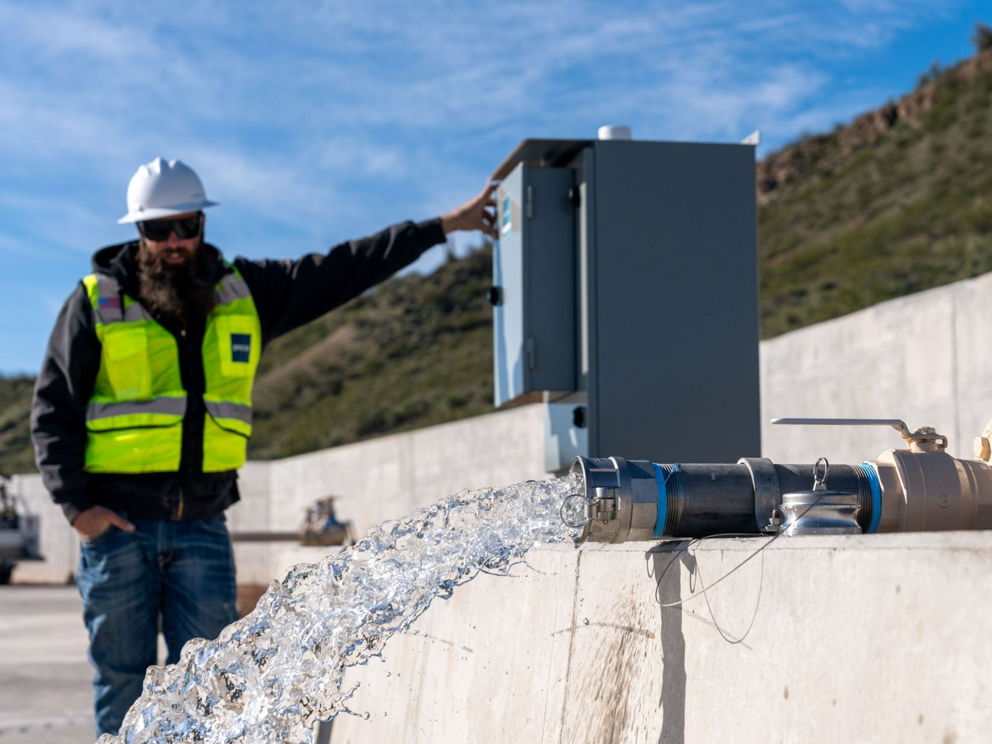 EPCOR worker stands next to the Rio Verde Foothills standpipe