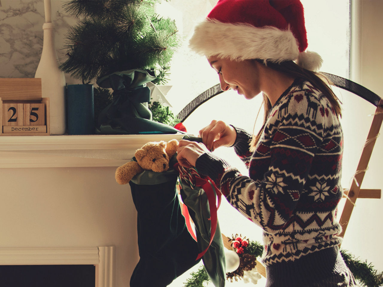 Woman sitting in front of a fan blowing air