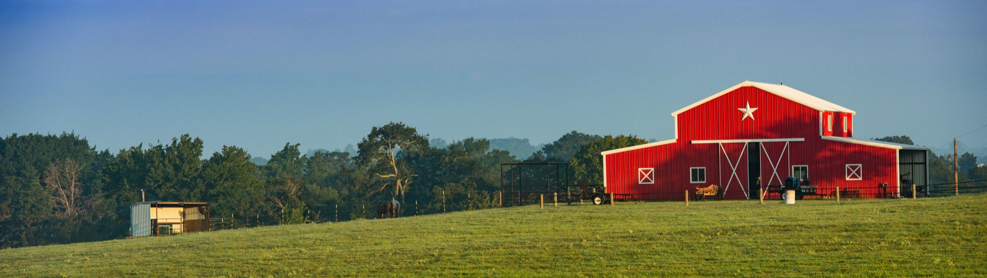 A red barn on the Texas landscape.