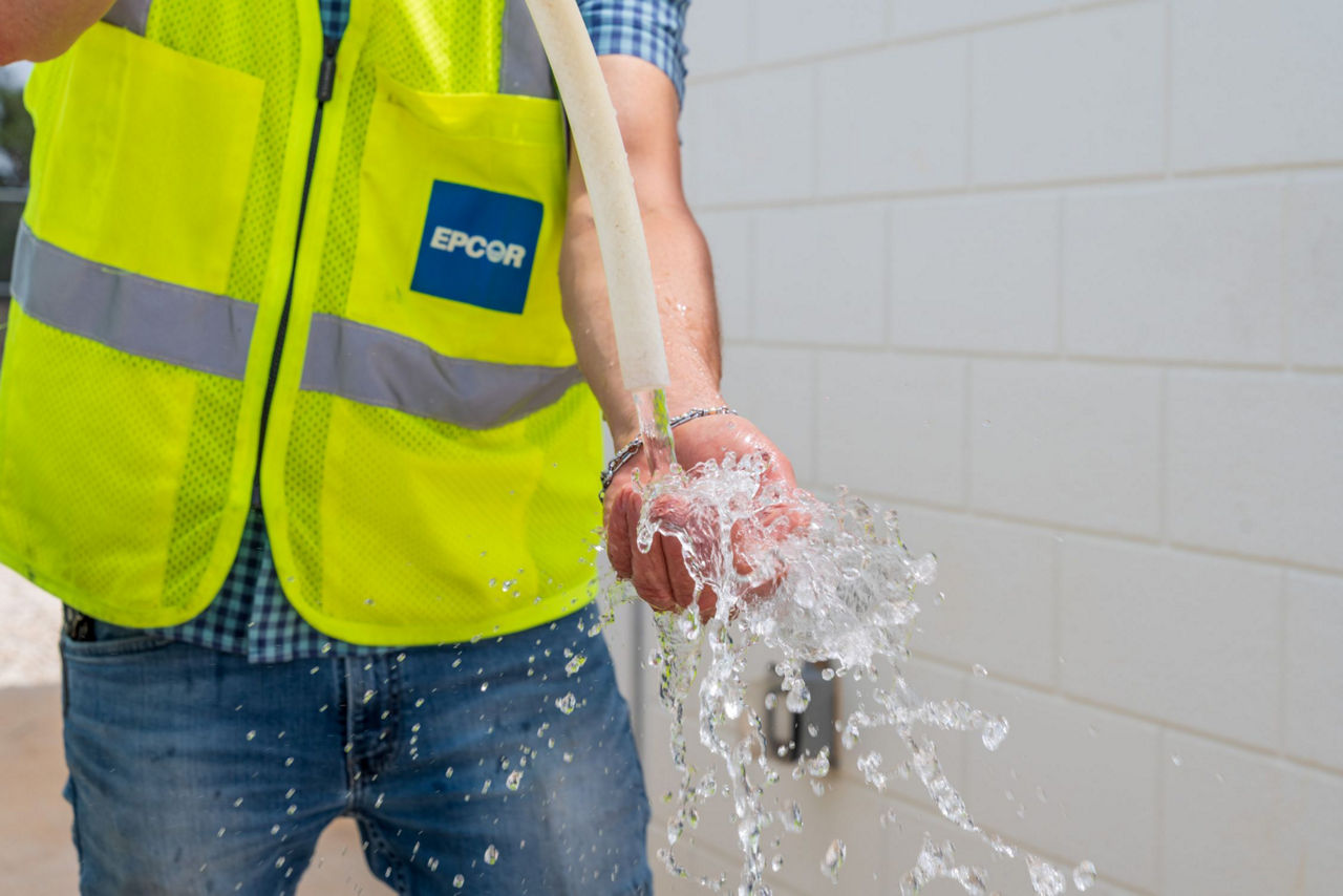 EPCOR employee demonstrates high quality clean drinking water.