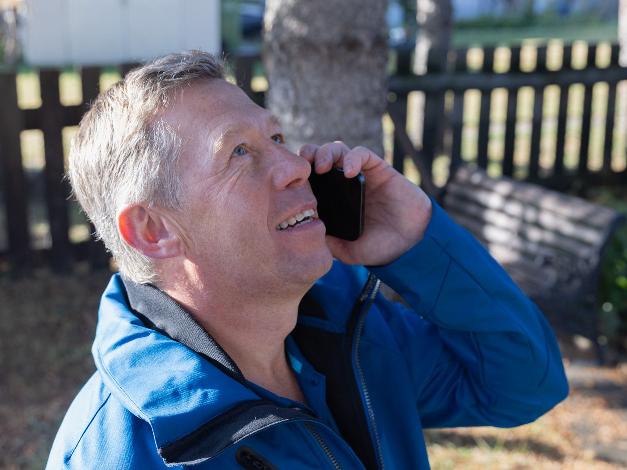 Person speaking on the phone requesting a safety codes consult before trimming trees