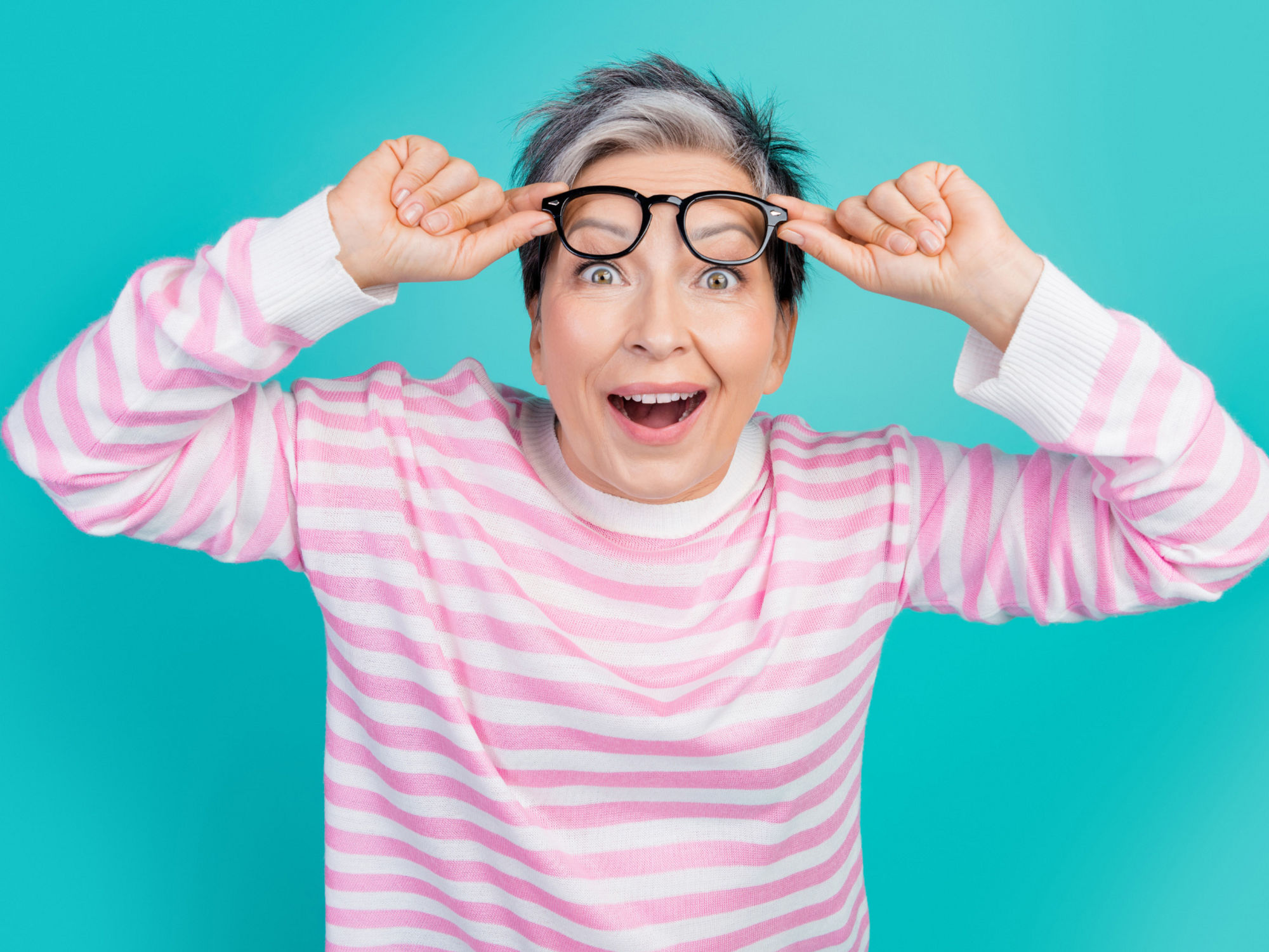 Encor Images  - woman holding glasses up