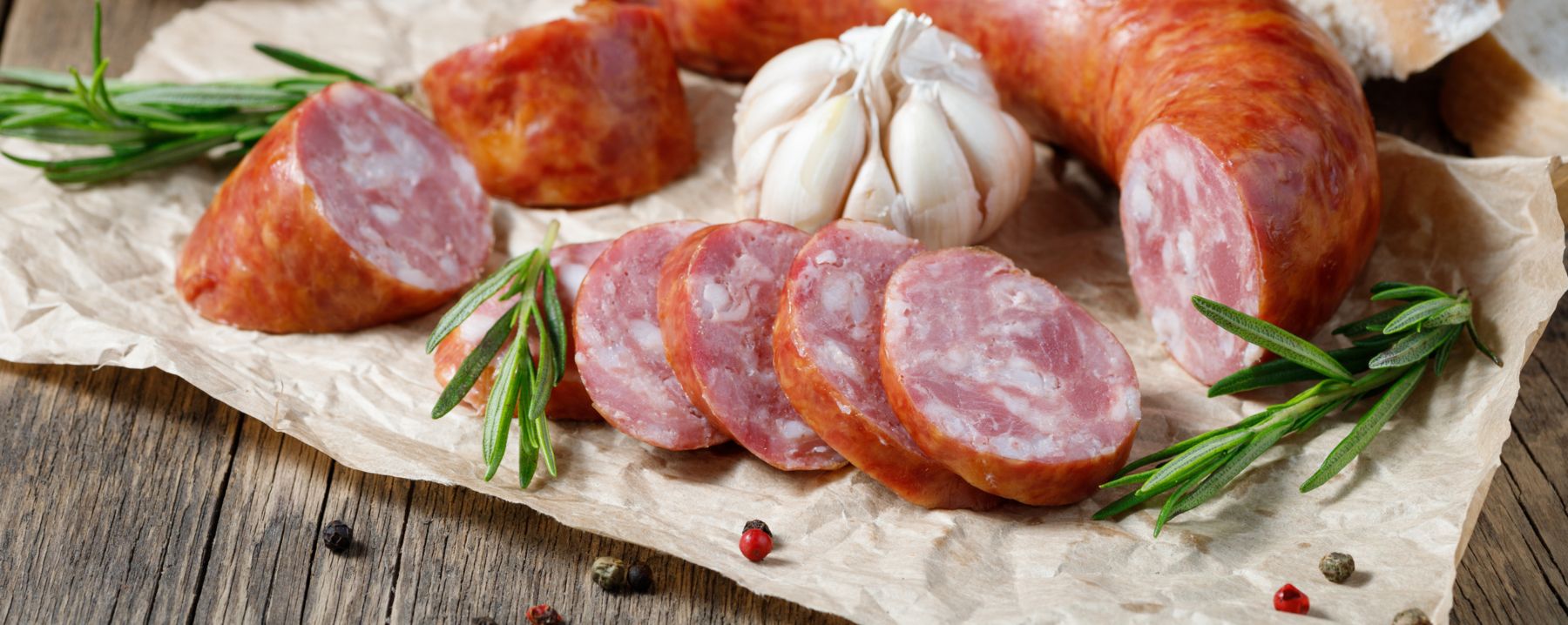 Smoked sausage on a wooden table. Rustic style.