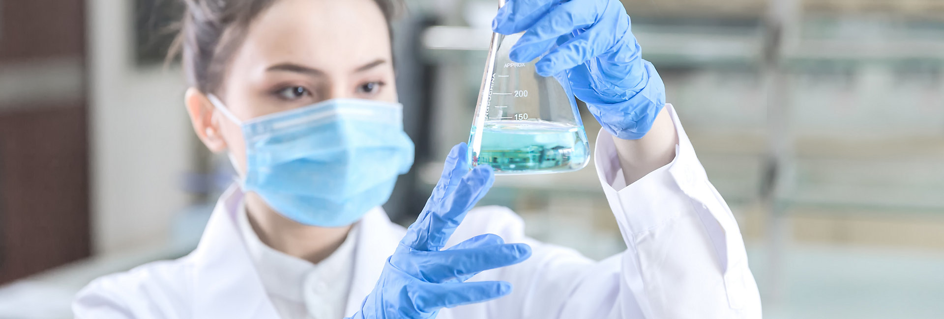 Female scientist looking at the scientific sample in the laboratory; Shutterstock ID 1027796005; purchase_order: -; job: -; client: -