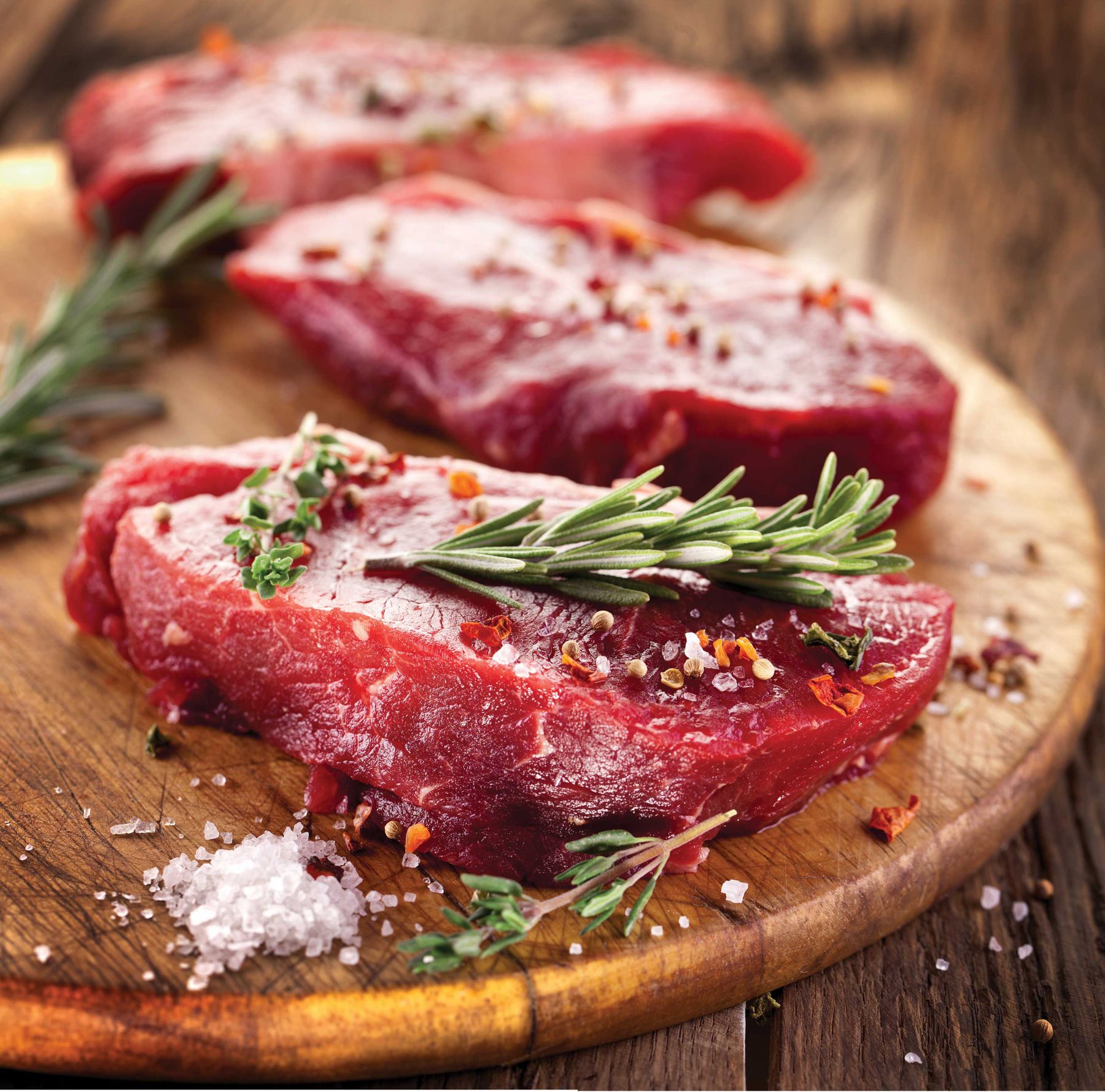 raw steak with rosemary