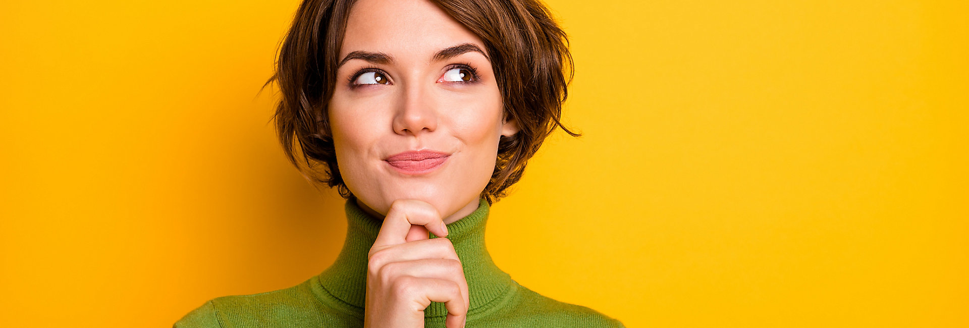 Closeup photo of amazing short hairdo lady looking up empty space deep thinking creative person arm on chin wear casual green turtleneck isolated yellow color background; Shutterstock ID 1617540484; purchase_order: -; job: -; client: -